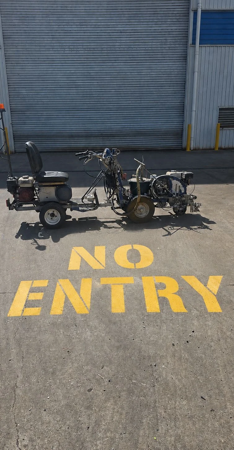 Freshly applied industrial line marking at a workshop entrance