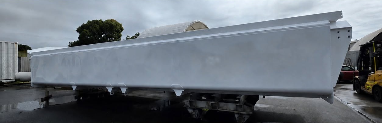 Large light-grey industrial structure in the All Paint Solutions workshop yard
